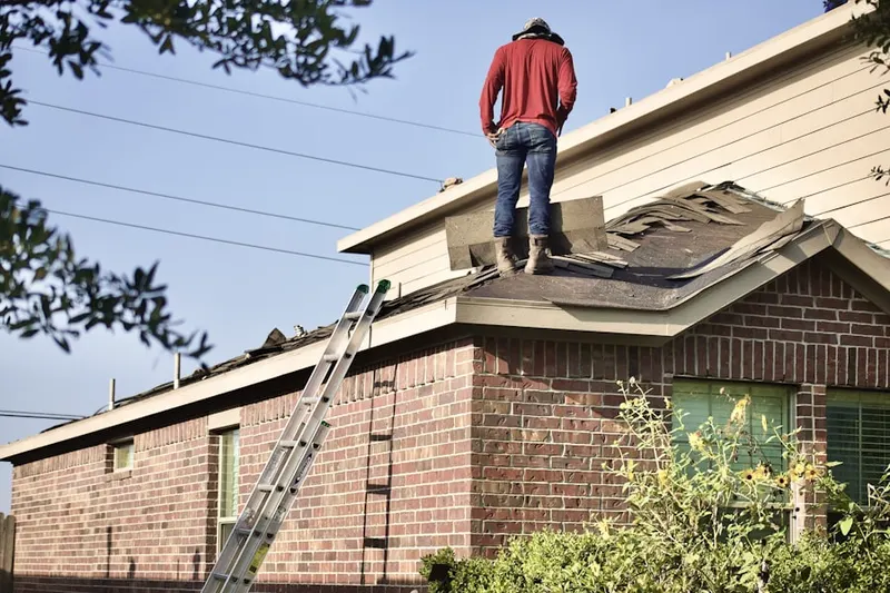 Professional roofer working on a residential roof in Prairie Village